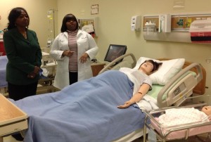 Northwestern College's Assistant Professor of Nursing Renita Sanders (right) provides IL State Rep Mary Flowers a tour of the College's Nursing Lab in Oak Lawn.