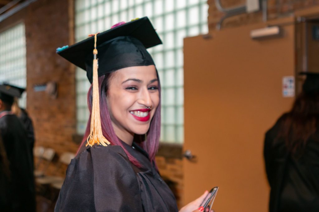 A student wears a graduation cap and gown