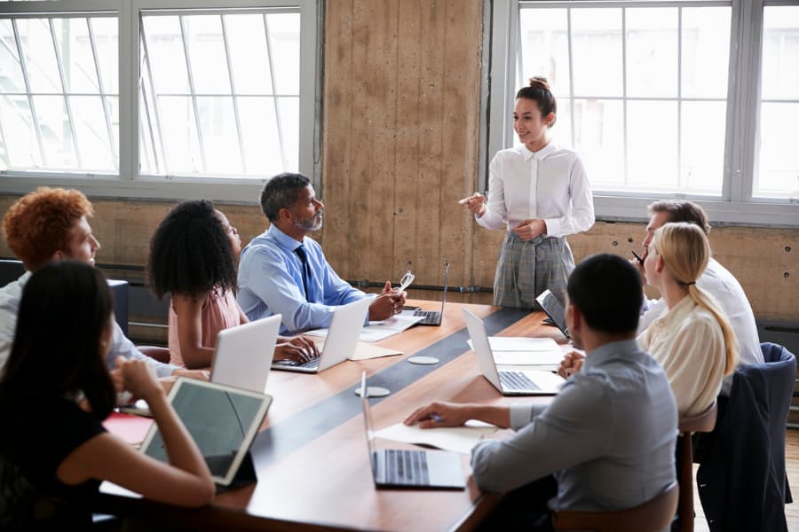 Woman running a meeting with her team
